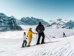 Skiing in the Grindelwald–Wengen ski area. The skier takes a break and enjoys the panoramic view of the sea of fog.