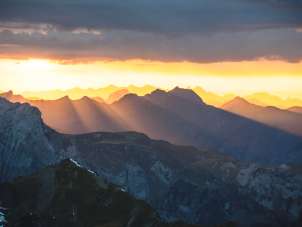 The mountains surrounding the Schilthorn refract the setting sun's light, creating a magical sunset.