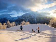 Winter in the Haslital Valley: A young family sledding on the Hasliberg.