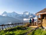 Hikers enjoy the panoramic view of the Eiger, Mönch, and Jungfrau at the Lobhorn Hut.