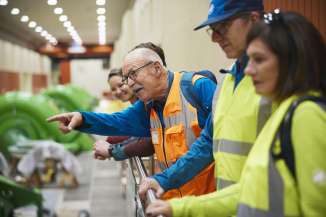 Grimselwelt, power plant tour with people wearing high-visibility vests.
