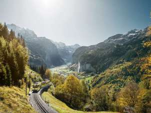 The Wengernalpbahn en route from Lauterbrunnen to Wengen. In the background, the Lauterbrunnen Valley, bathed in fall colors, with the Staubbach Falls.
