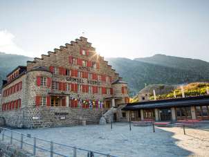 The sun is shining from behind the Grimsel Hospiz Hotel.