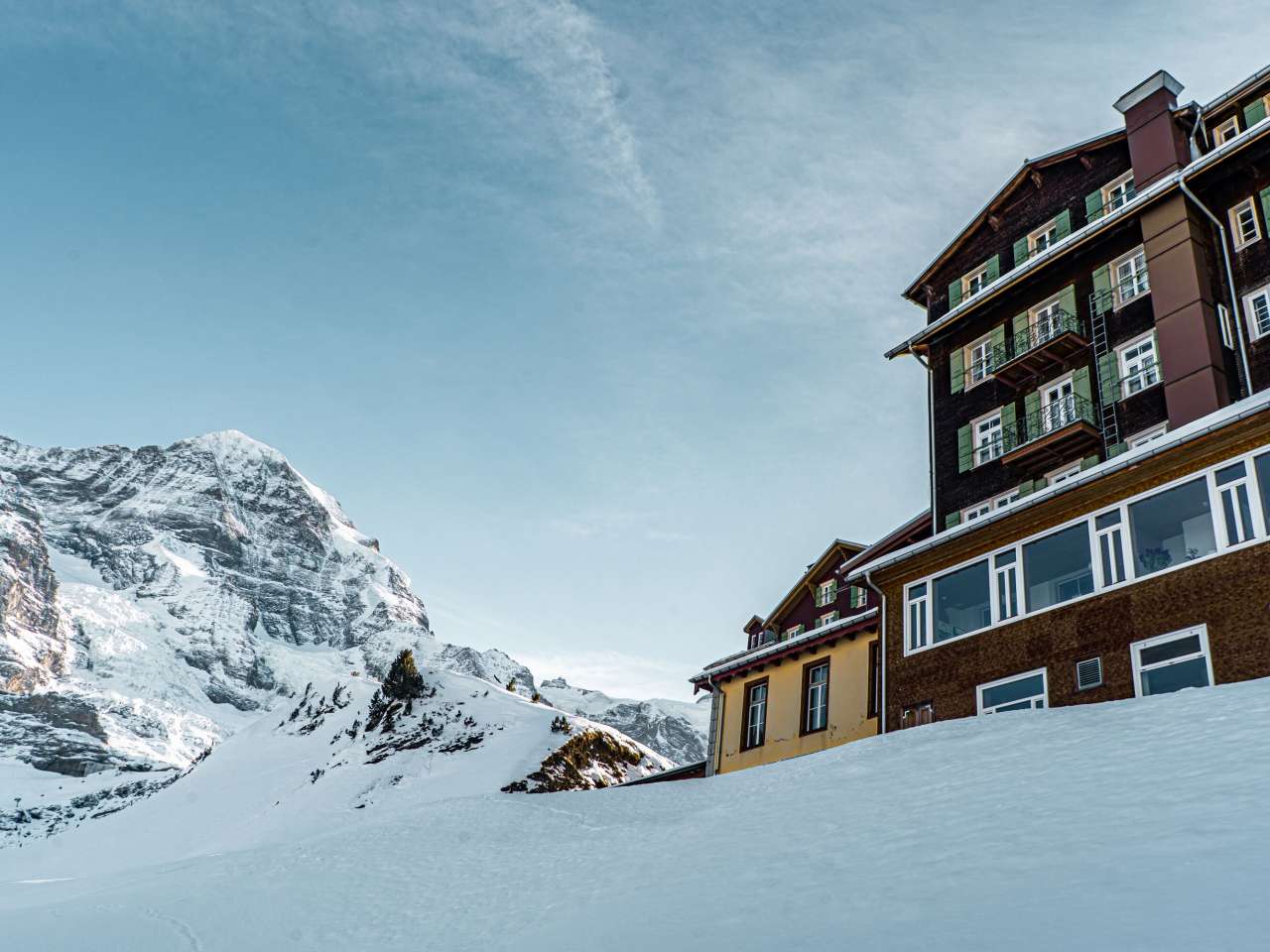 The Hotel Bellvue des Alpes stands on the snow-covered Kleine Scheidegg. The Eiger can be seen in the background.