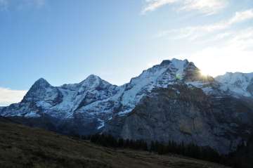 The snow-capped trio of the Eiger, Mönch, and Jungfrau in summer.