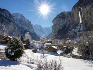 The village of Lauterbrunnen in winter, with its church and the Staubbach Falls.