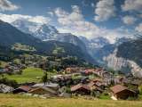 Behind the summery village of Wengen, you can see the Lauterbrunnen Valley with its steep cliffs.
