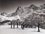 Winter nostalgia in Mürren. The group watches the ski instructor with eager interest. In the background stand the snow-covered Eiger and Mönch.
